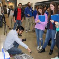 project designer showing their robot to students